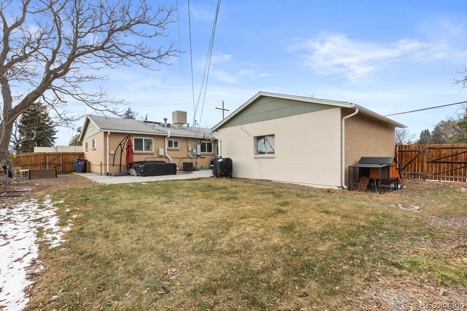 3106 South Wolff Street Denver, CO 80236 - Photo 48 of 48 a front view of a house with a yard