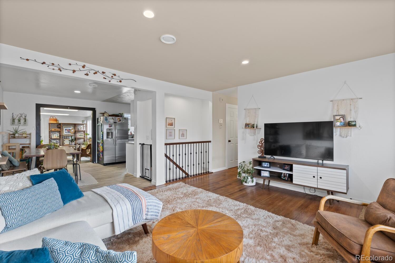 3106 South Wolff Street Denver, CO 80236 - Photo 5 of 48 a living room with furniture and a flat screen tv
