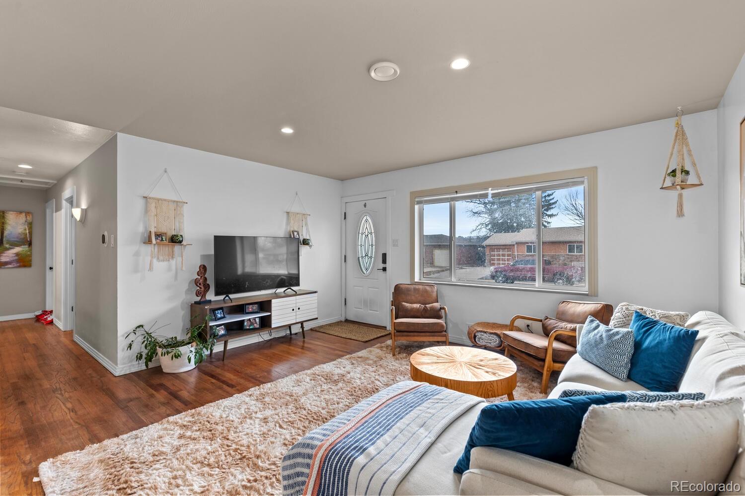 3106 South Wolff Street Denver, CO 80236 - Photo 6 of 48 a living room with furniture and a flat screen tv