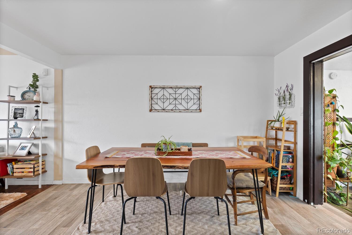 3106 South Wolff Street Denver, CO 80236 - Photo 10 of 48 a view of a dining room with furniture and wooden floor