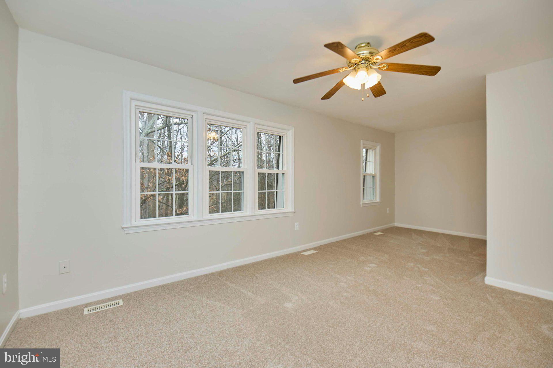 9007 O'Keith Court Springfield, VA 22152 - Photo 14 of 39 an empty room with window and chandelier fan