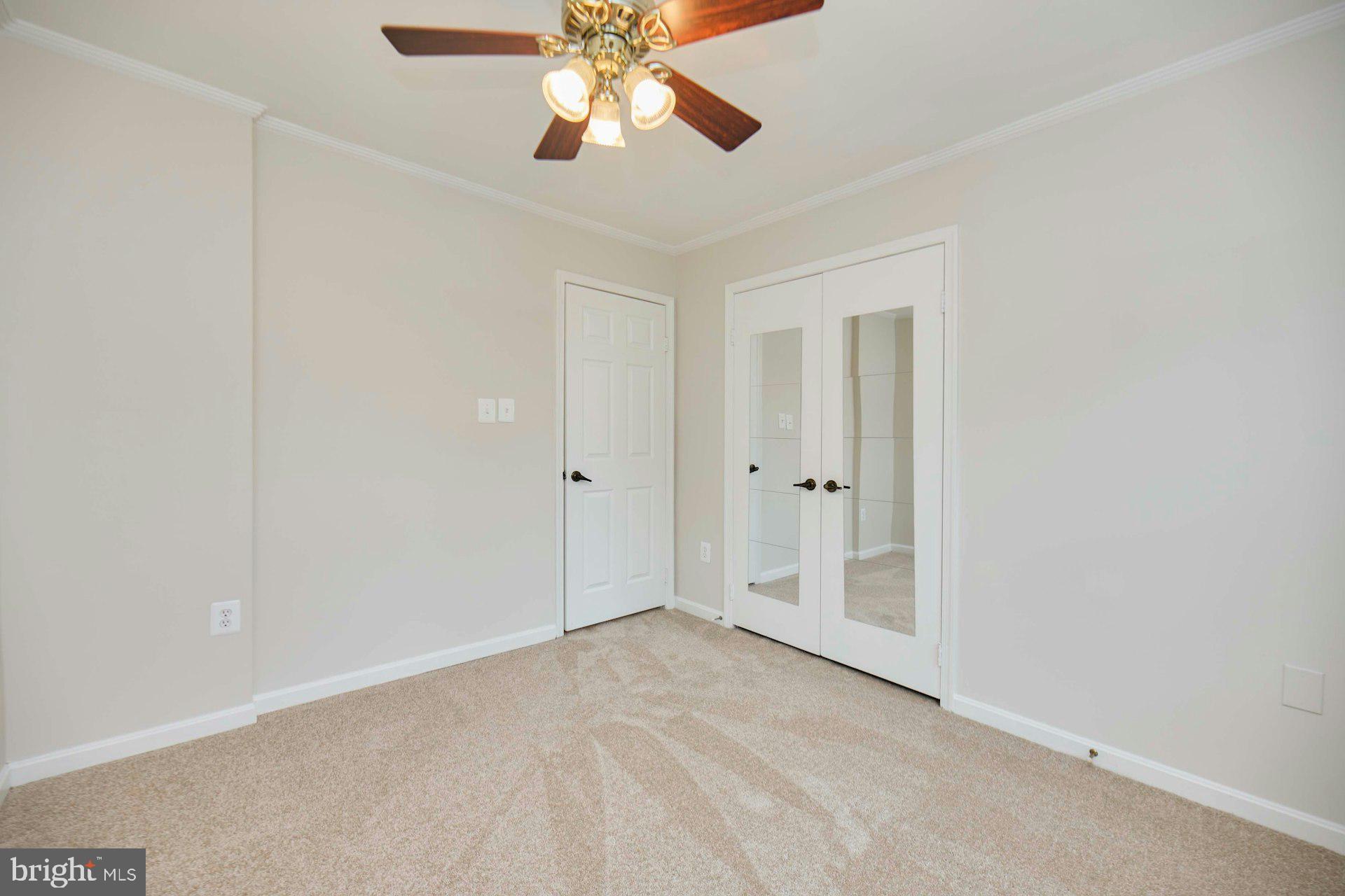 9007 O'Keith Court Springfield, VA 22152 - Photo 20 of 39 an empty room with closet and a chandelier fan