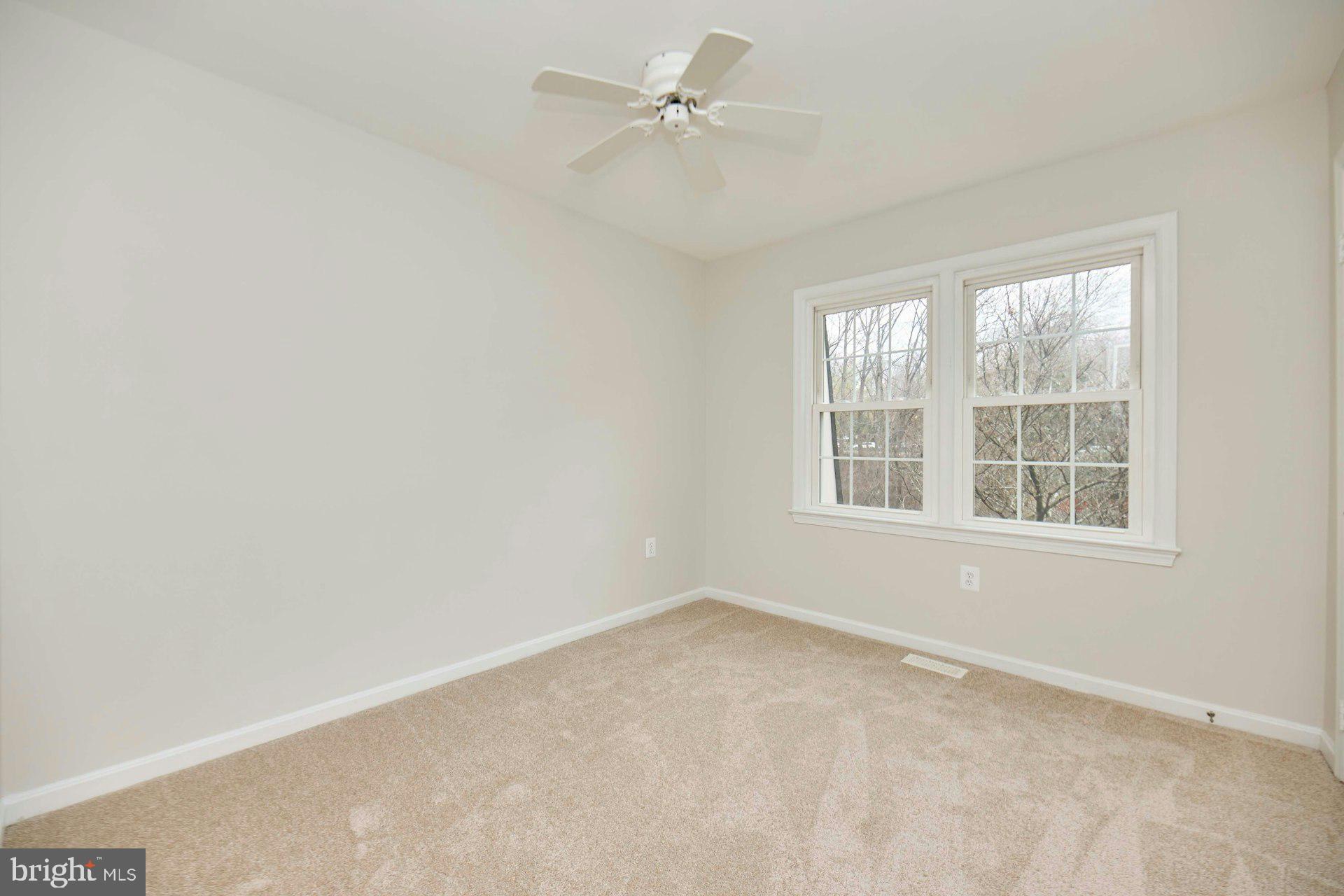 9007 O'Keith Court Springfield, VA 22152 - Photo 22 of 39 an empty room with a window and a fan