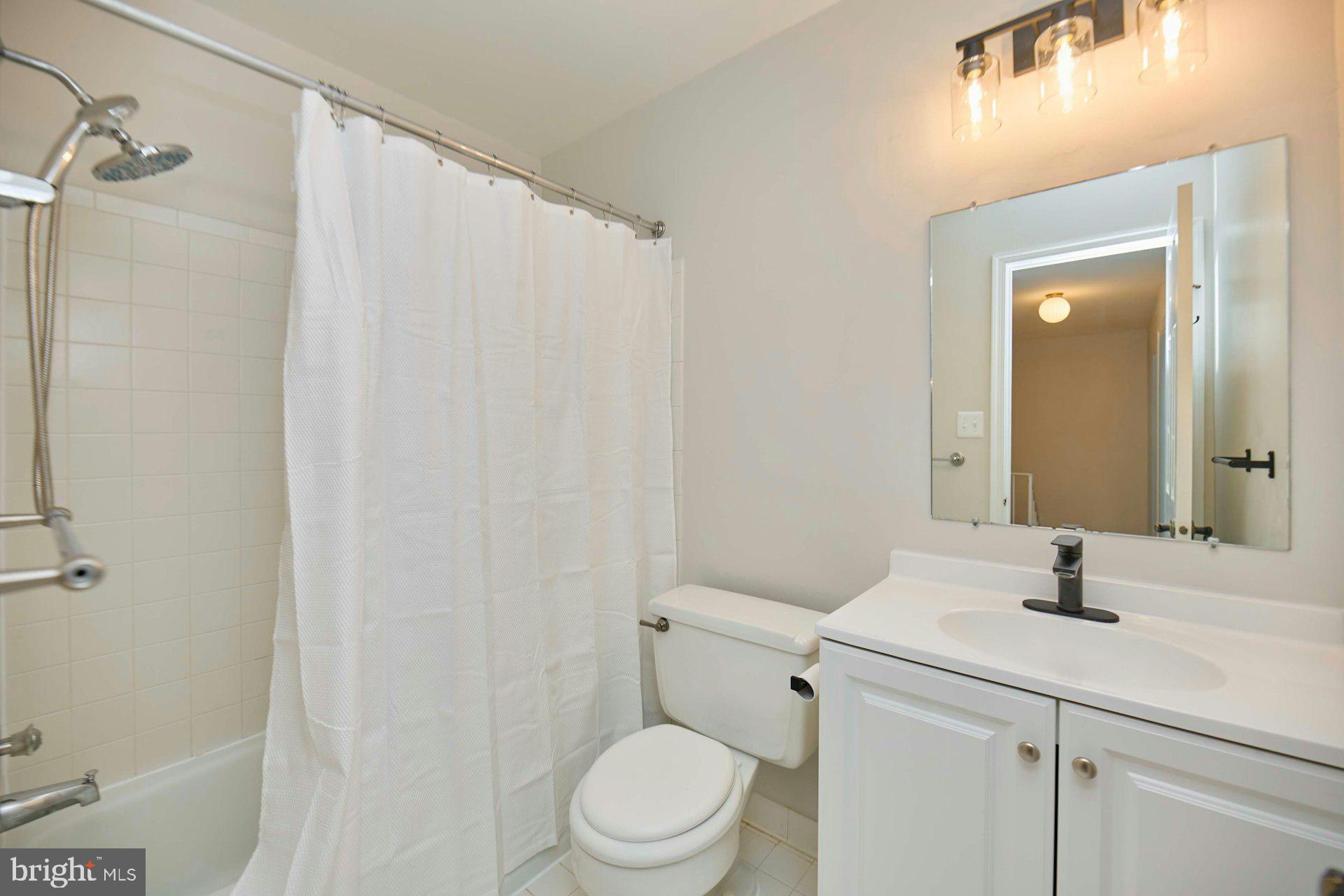 9007 O'Keith Court Springfield, VA 22152 - Photo 23 of 39 a bathroom with a sink a toilet and shower