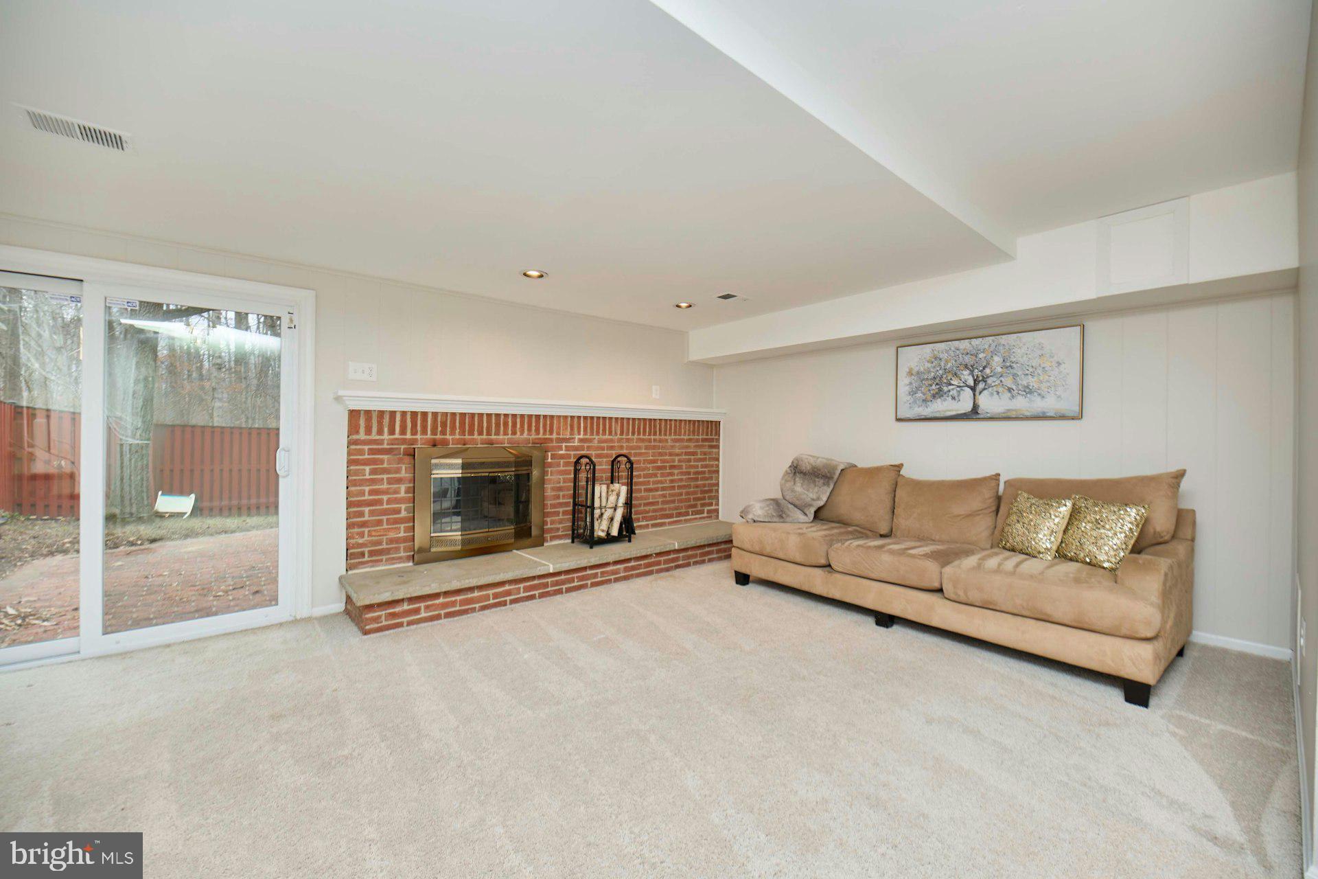 9007 O'Keith Court Springfield, VA 22152 - Photo 25 of 39 a living room with furniture and a fireplace