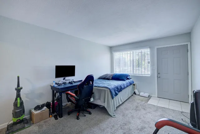 a bedroom with a bed and a window