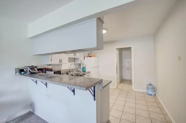 a kitchen with stainless steel appliances a sink stove and cabinets