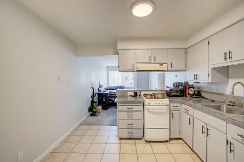 a kitchen with cabinets appliances and a sink