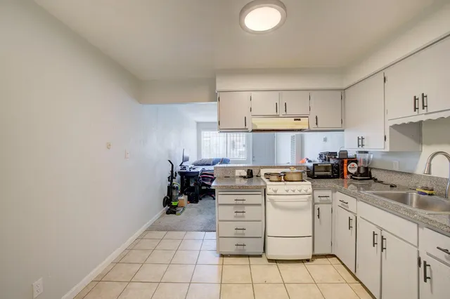 a kitchen with cabinets appliances and a sink
