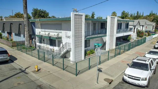 a view of a patio with table and chairs potted plants with wooden floor and fence