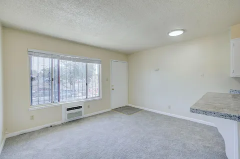 a kitchen that has a sink a stove and cabinets