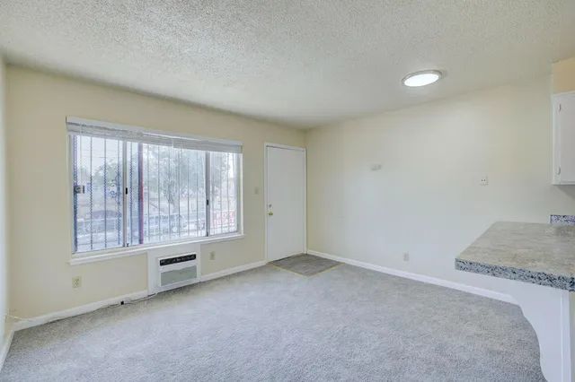 a kitchen that has a sink a stove and cabinets