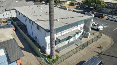 a view of a white building with large windows