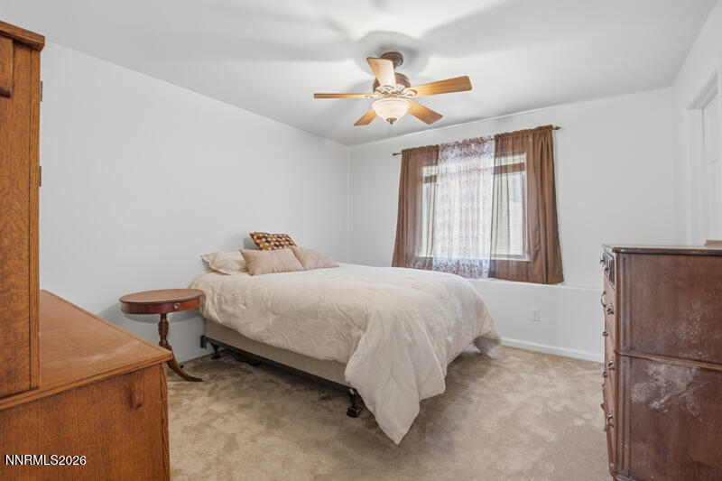 1367 Calavaras Road Reno, NV 89521 - Photo 18 of 26 a bedroom with a bed and a chandelier