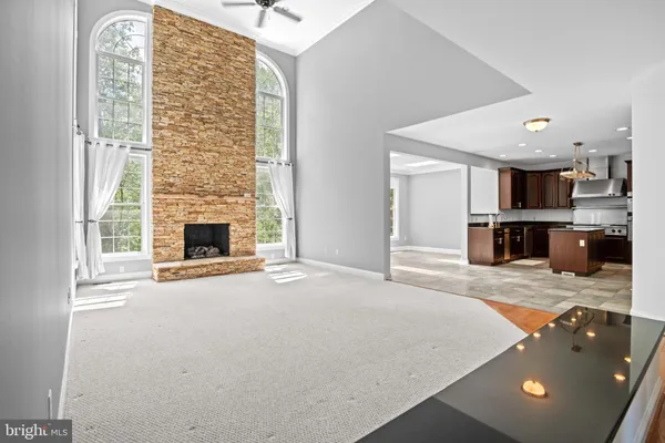 an empty room with a fireplace and windows