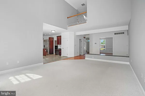 a view of empty room with fireplace and wooden floor