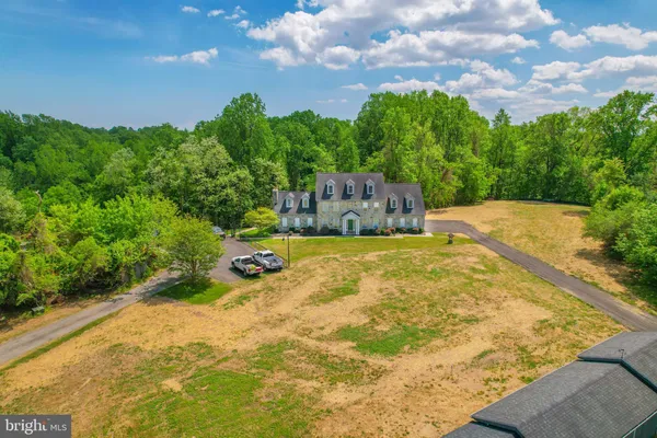 a view of a swimming pool with an outdoor seating and a yard