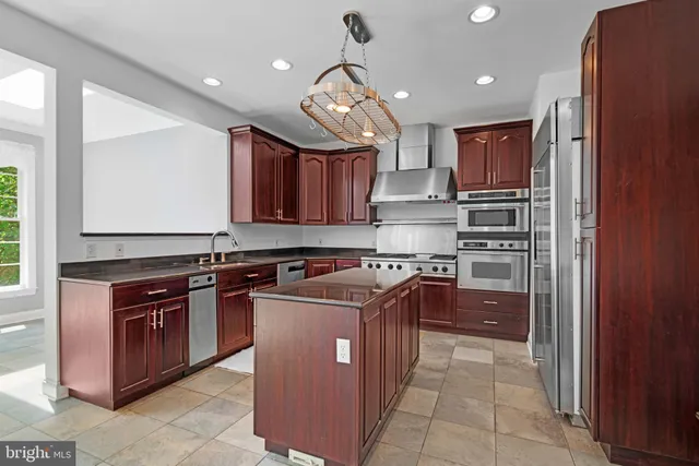 a kitchen with stainless steel appliances granite countertop a stove and a sink