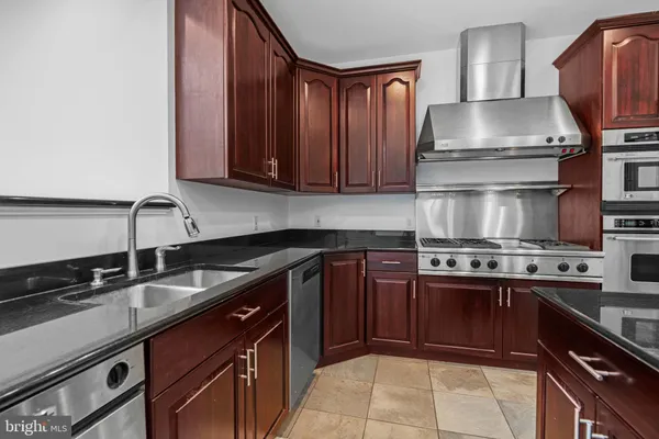 a stove top oven sitting inside of a kitchen