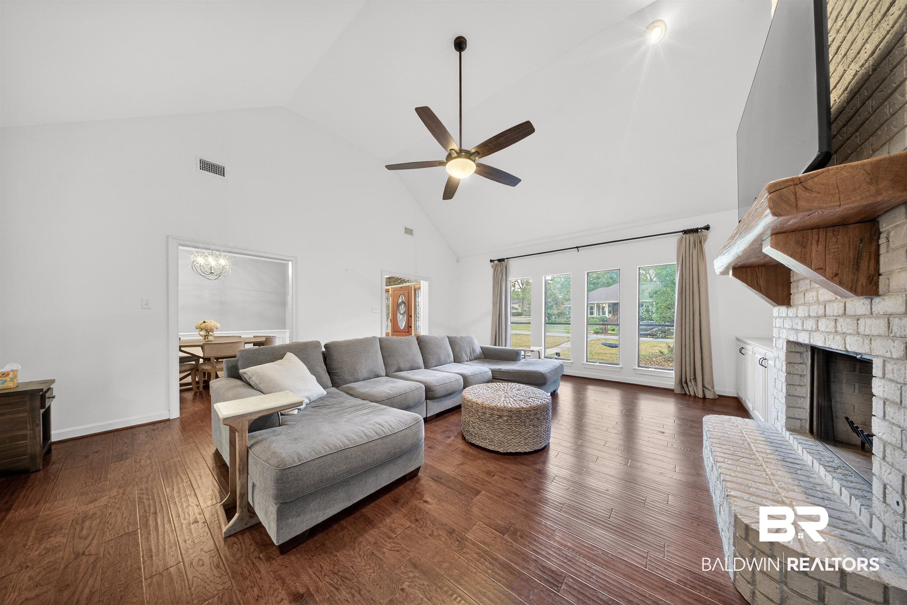 1250 Savannah Drive Mobile, AL 36609 - Photo 11 of 35 Living room with a high ceiling, dark wood-type flooring, ceiling fan, and a fireplace