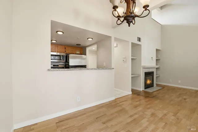 a view of a kitchen with a sink and a refrigerator