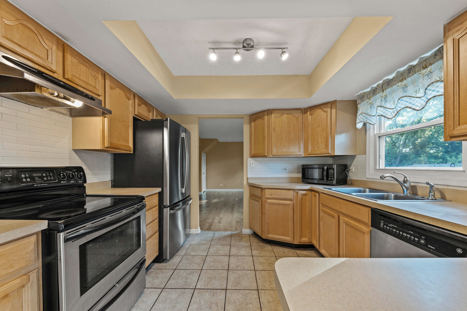 1121 Belmar Lane Buffalo Grove, IL 60089 - Photo 13 of 22 a kitchen with stainless steel appliances a stove sink and cabinets