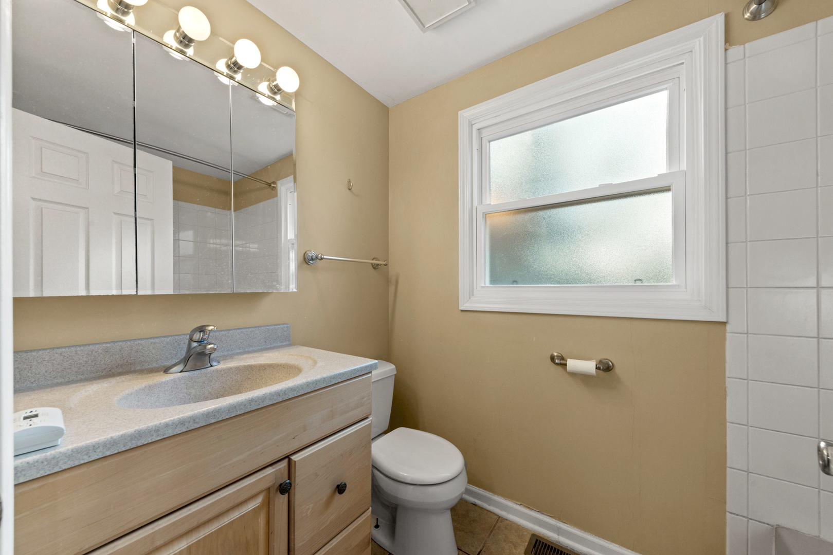 1121 Belmar Lane Buffalo Grove, IL 60089 - Photo 16 of 22 a bathroom with a toilet a sink a vanity and mirror