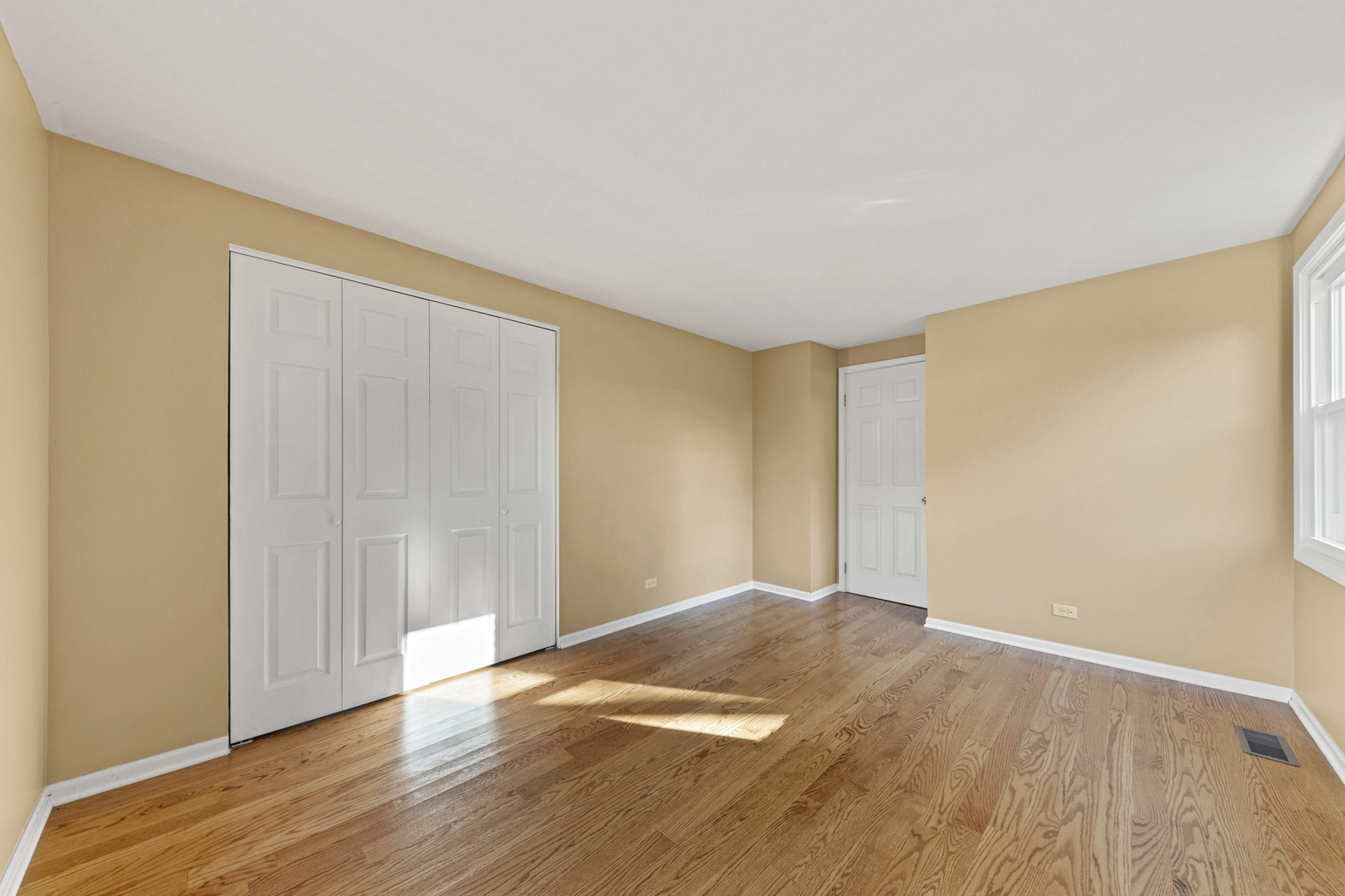 1121 Belmar Lane Buffalo Grove, IL 60089 - Photo 18 of 22 a view of an empty room with wooden floor