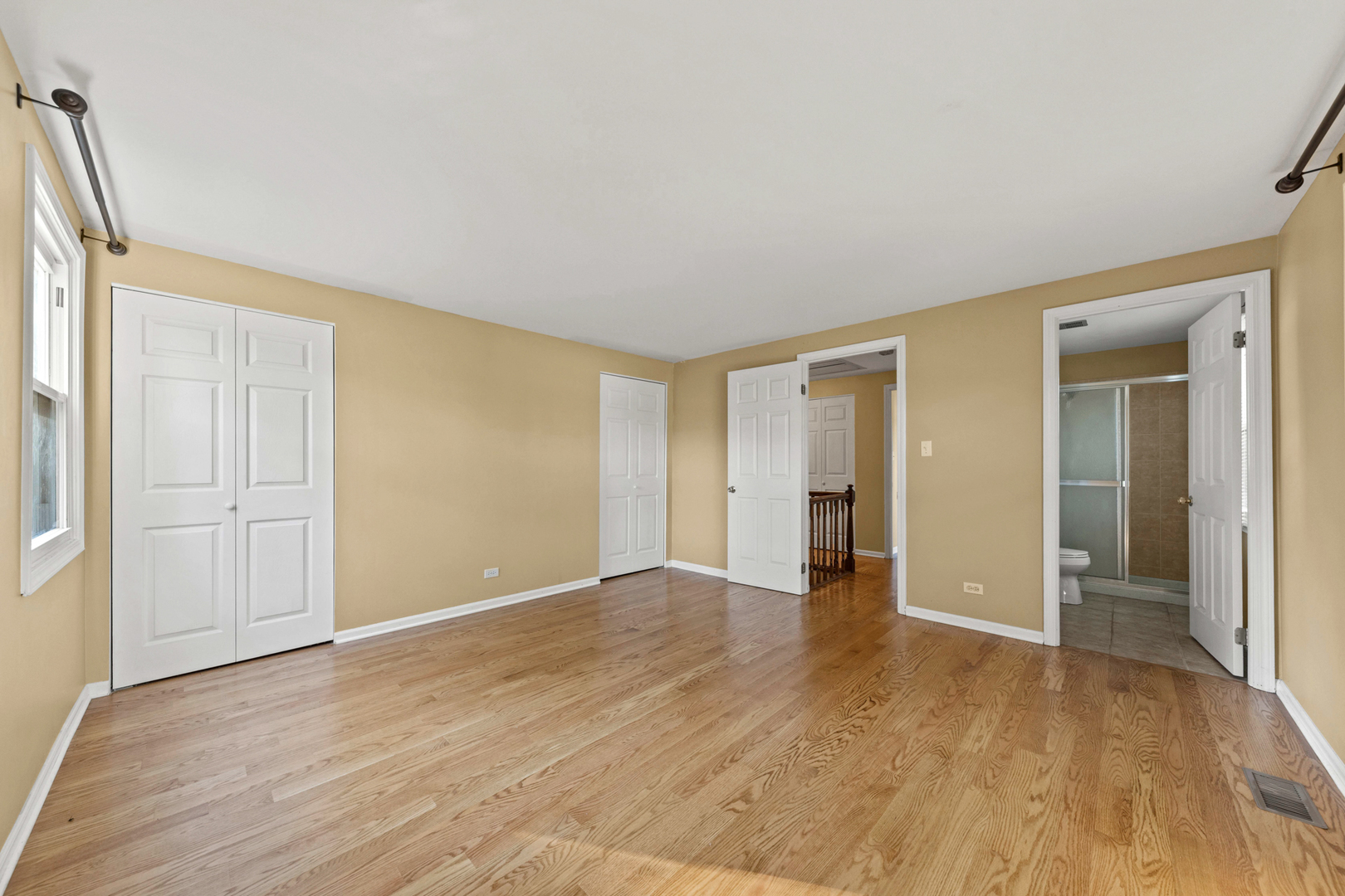 1121 Belmar Lane Buffalo Grove, IL 60089 - Photo 20 of 22 a view of an empty room with wooden floor and a window