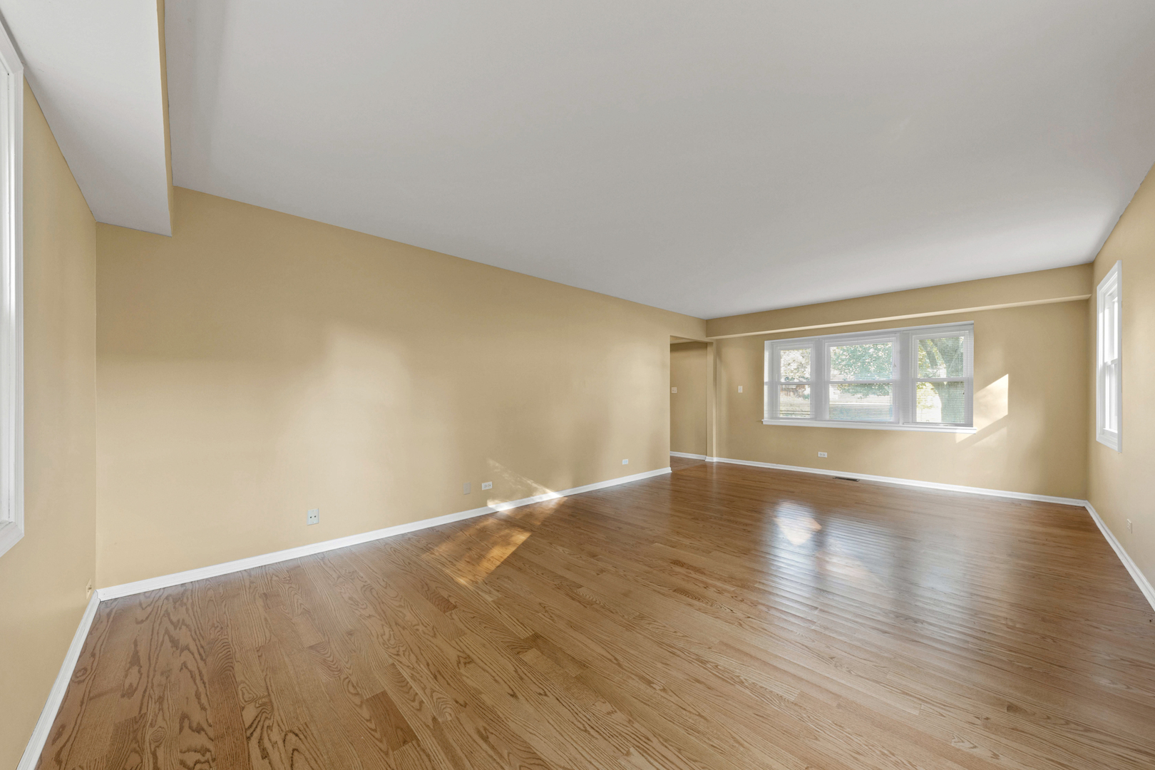 1121 Belmar Lane Buffalo Grove, IL 60089 - Photo 4 of 22 a view of an empty room with wooden floor and a window