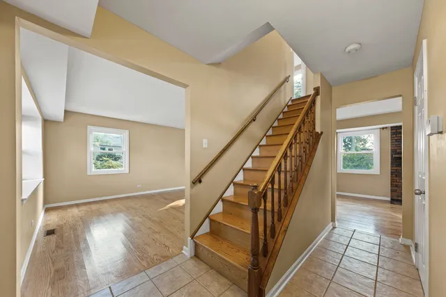 a view of entryway with wooden floor and stairs