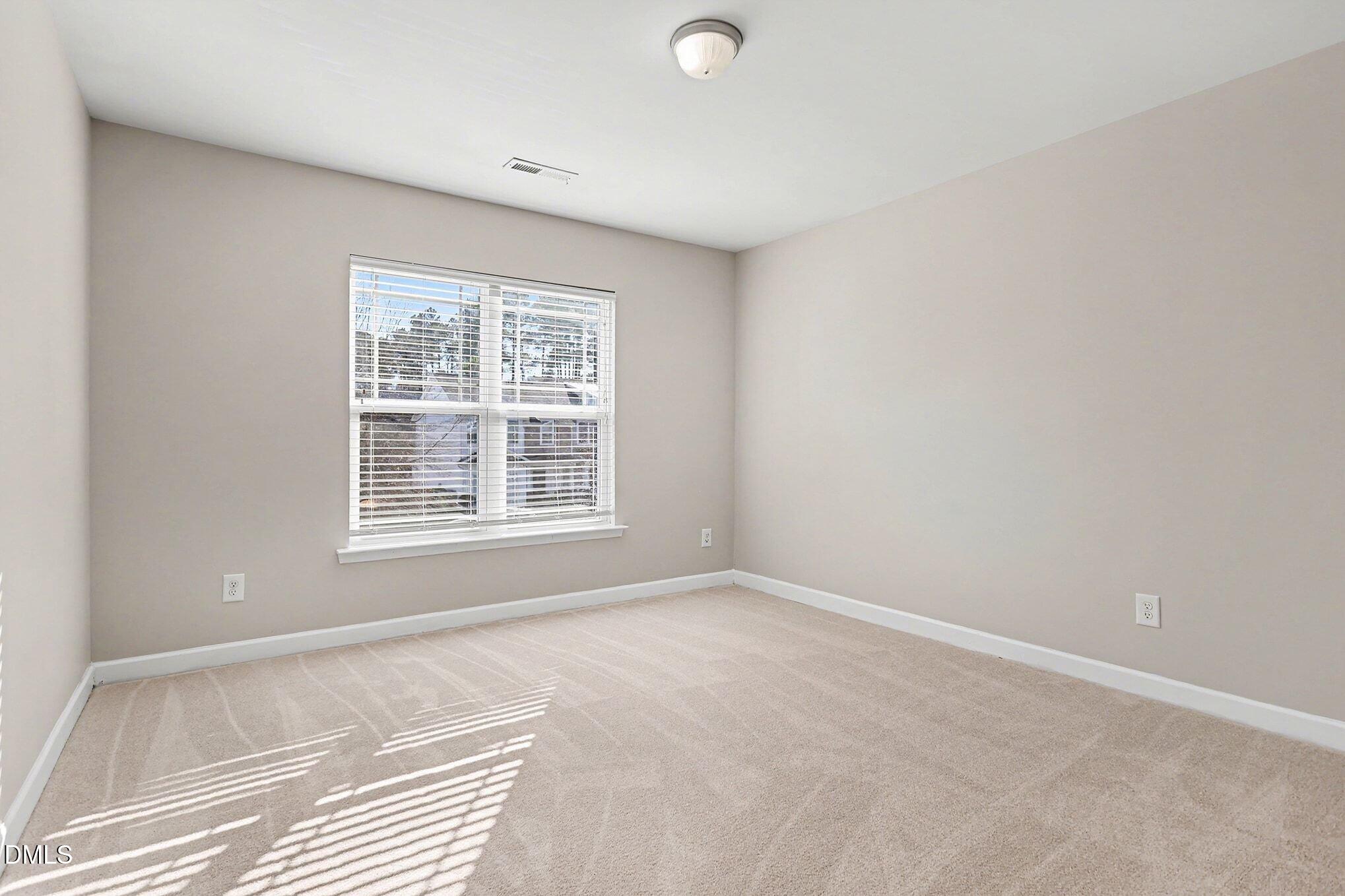 4818 Landover Bluff Way Raleigh, NC 27616 - Photo 22 of 30 a view of an empty room with a window