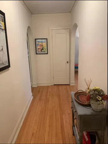 a view of a hallway with wooden floor