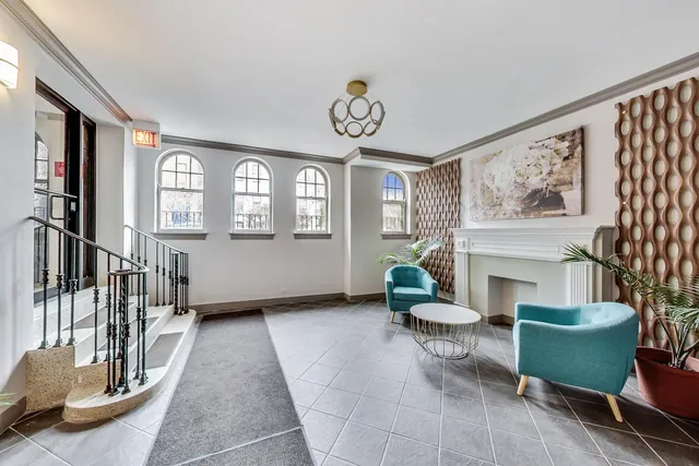 a living room with furniture a window and a fireplace