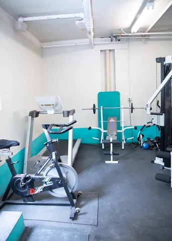 a room with furniture and gym equipment