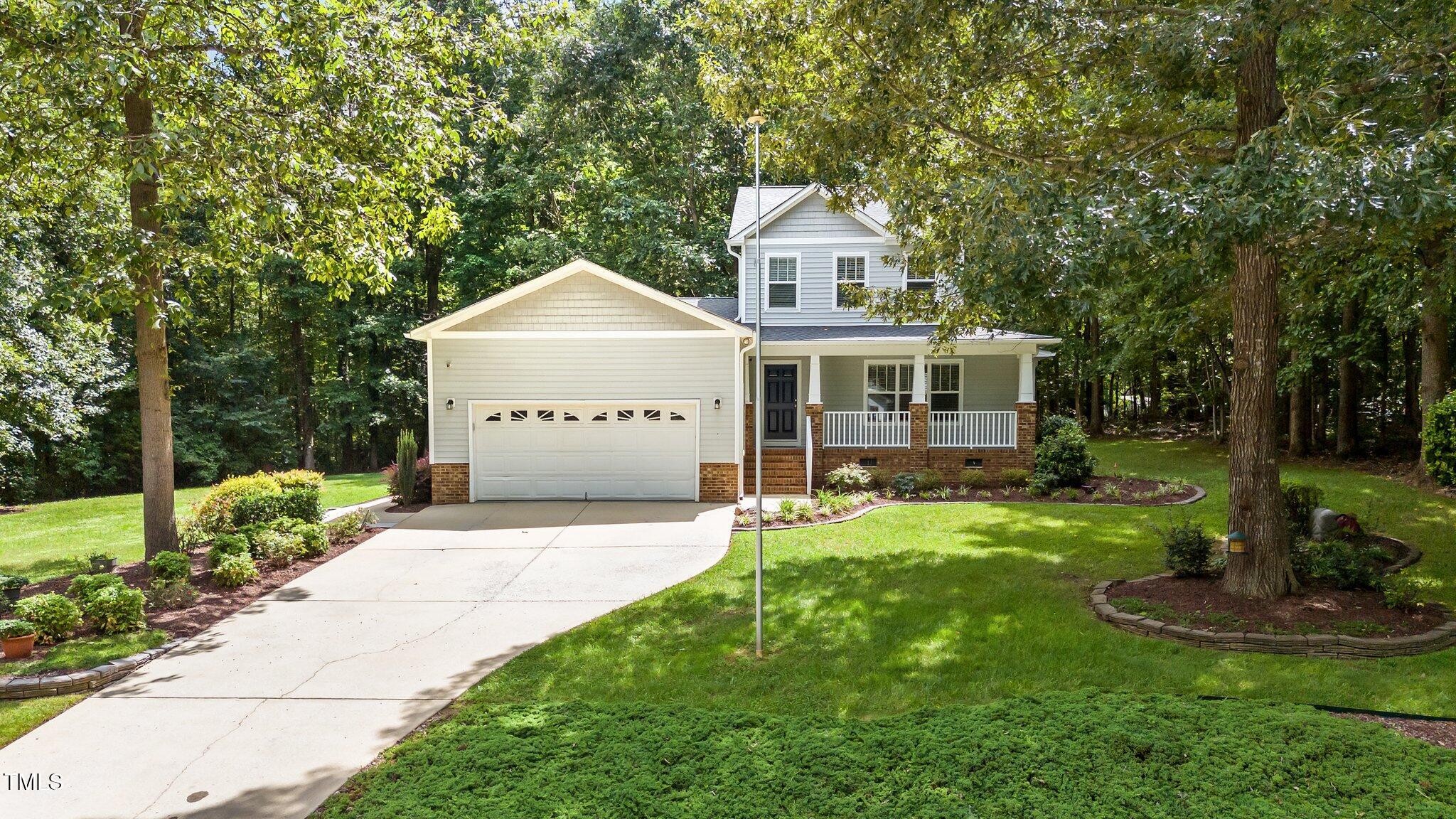 2713 Rustic Brick Road Raleigh, NC 27603 - Photo 3 of 53 a front view of a house with a yard and trees