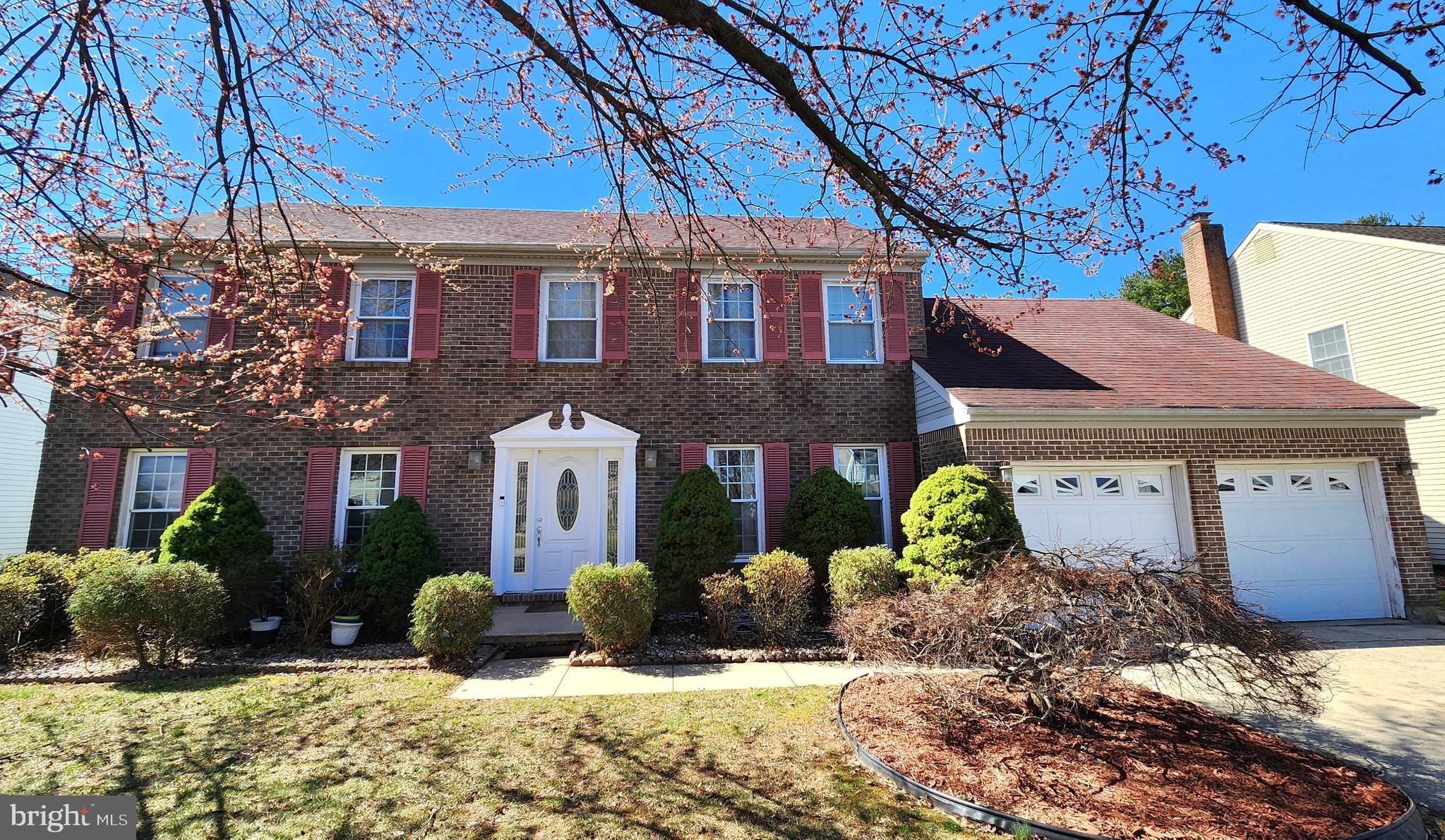 a view of a brick house with a yard