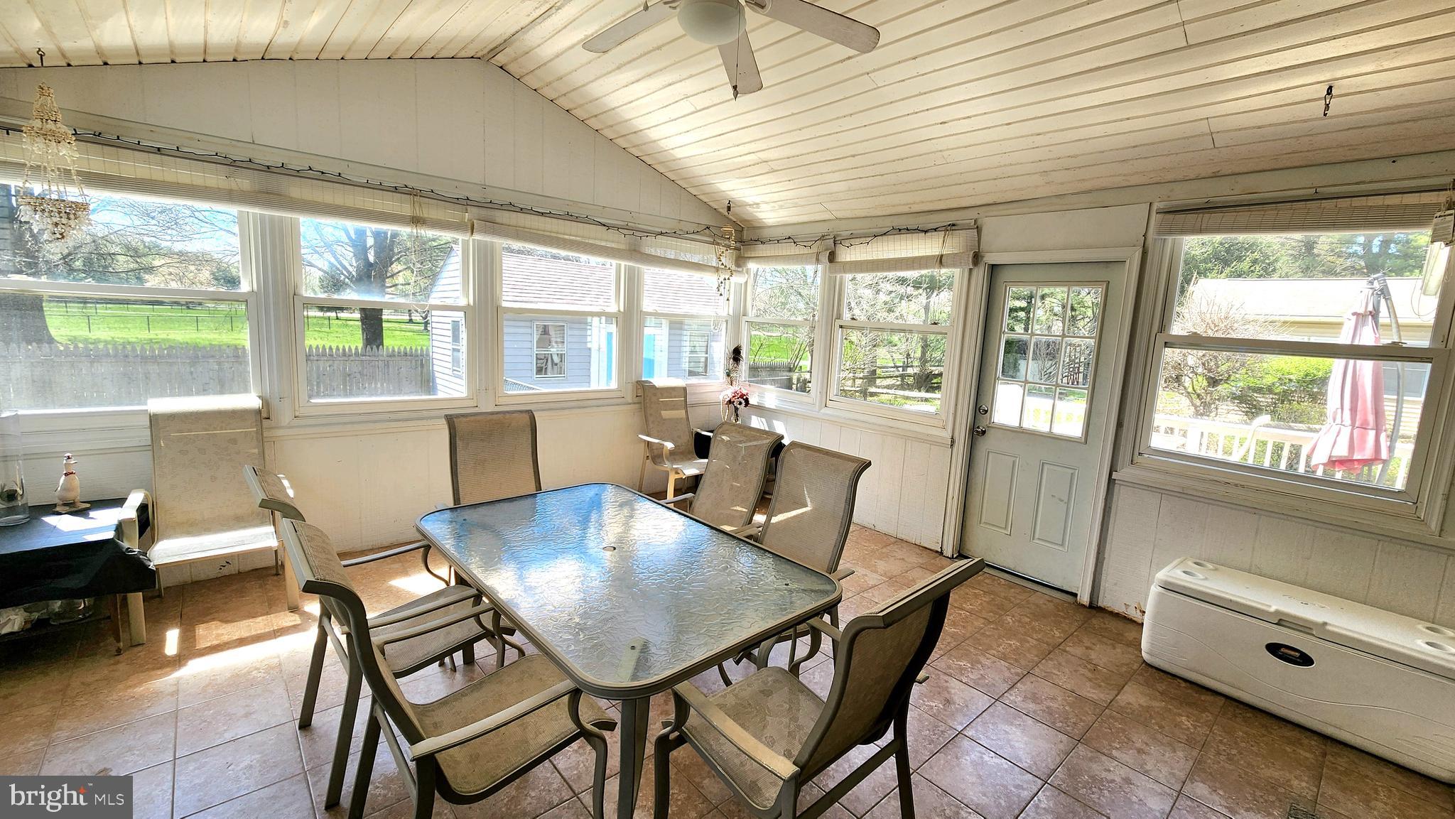 46 Currant Drive Newark, DE 19702 - Photo 20 of 47 a view of a dining room with furniture large windows and wooden floor