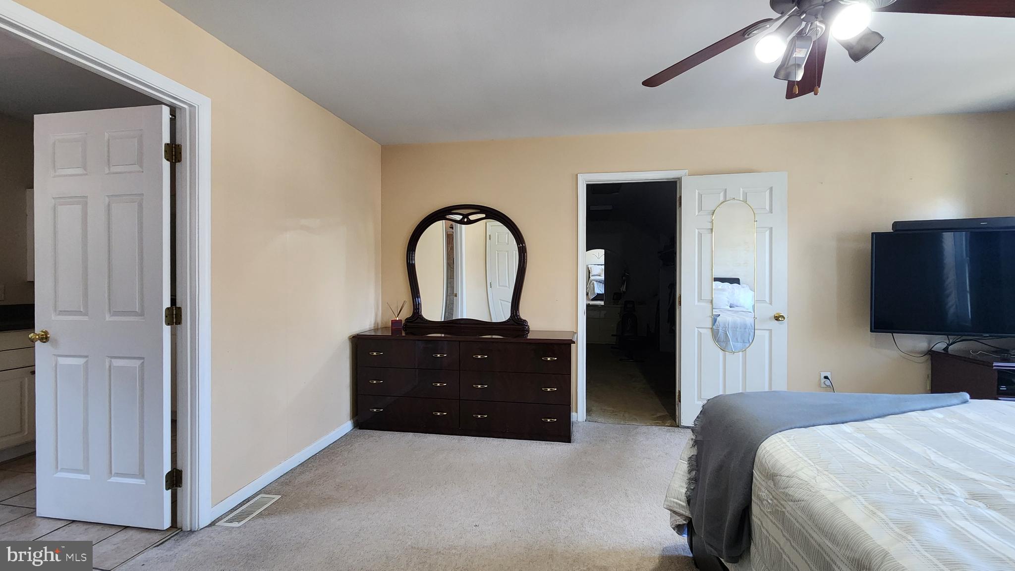 46 Currant Drive Newark, DE 19702 - Photo 34 of 47 a bedroom with a bed and a flat tv screen on dresser