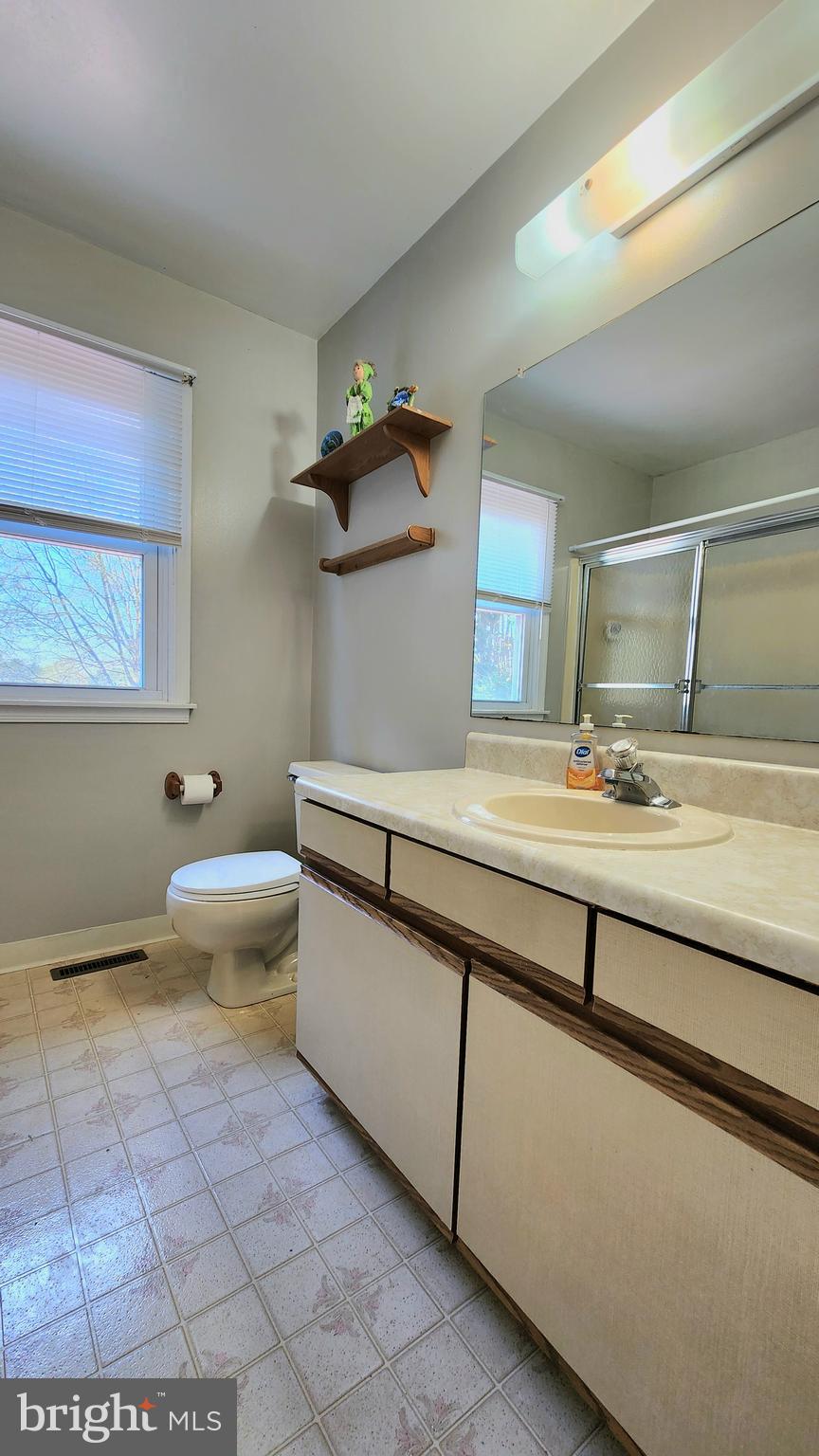 46 Currant Drive Newark, DE 19702 - Photo 44 of 47 a bathroom with a granite countertop sink a toilet and a mirror