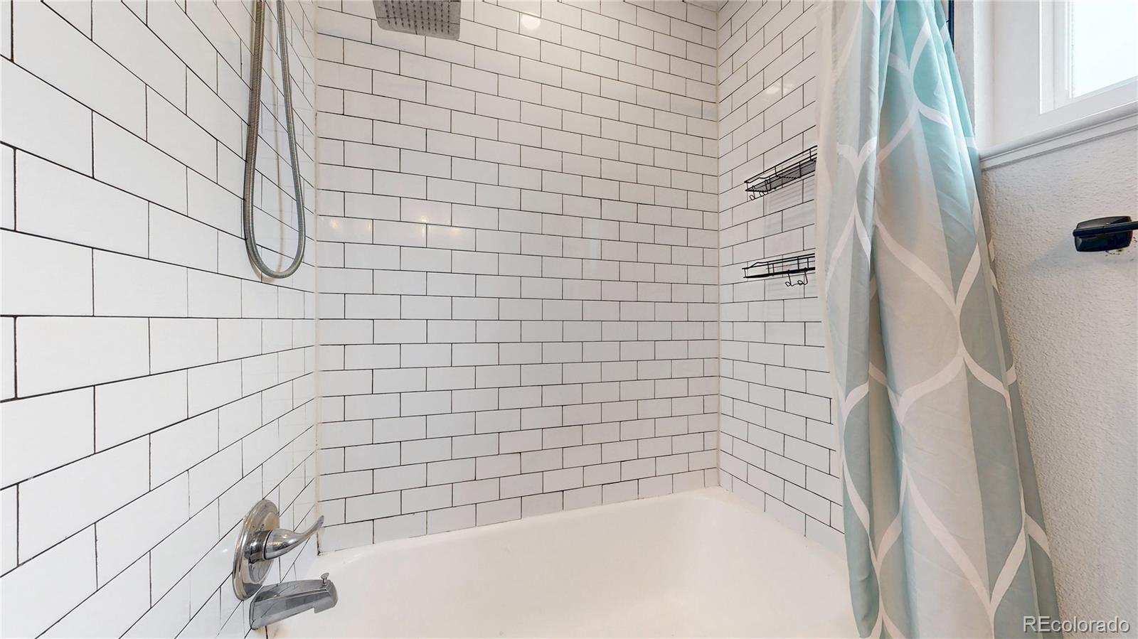 3155 Steele Street Denver, CO 80205 - Photo 14 of 37 a bathroom with a bathtub