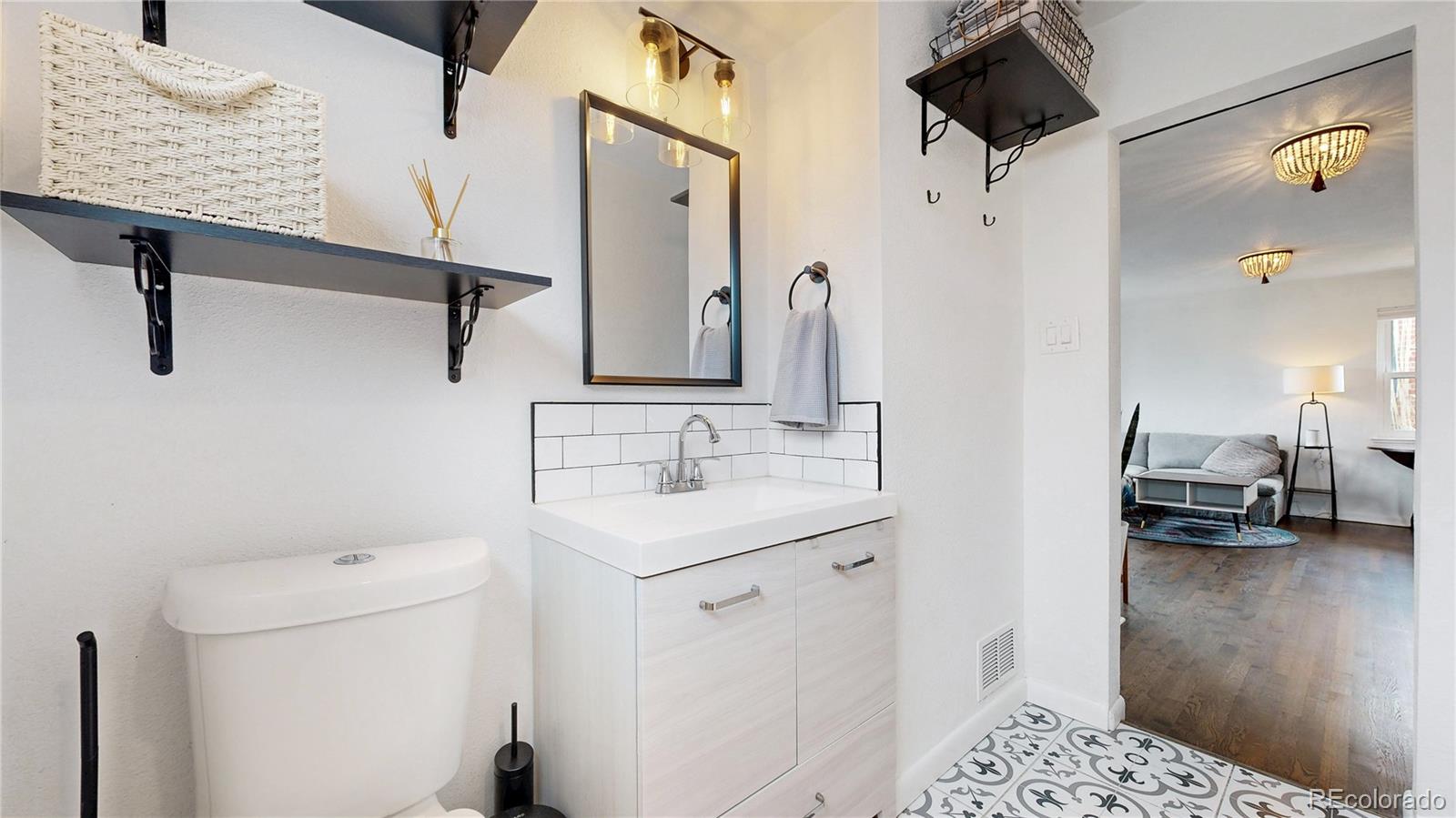 3155 Steele Street Denver, CO 80205 - Photo 15 of 37 a en suite bathroom with a sink and a mirror