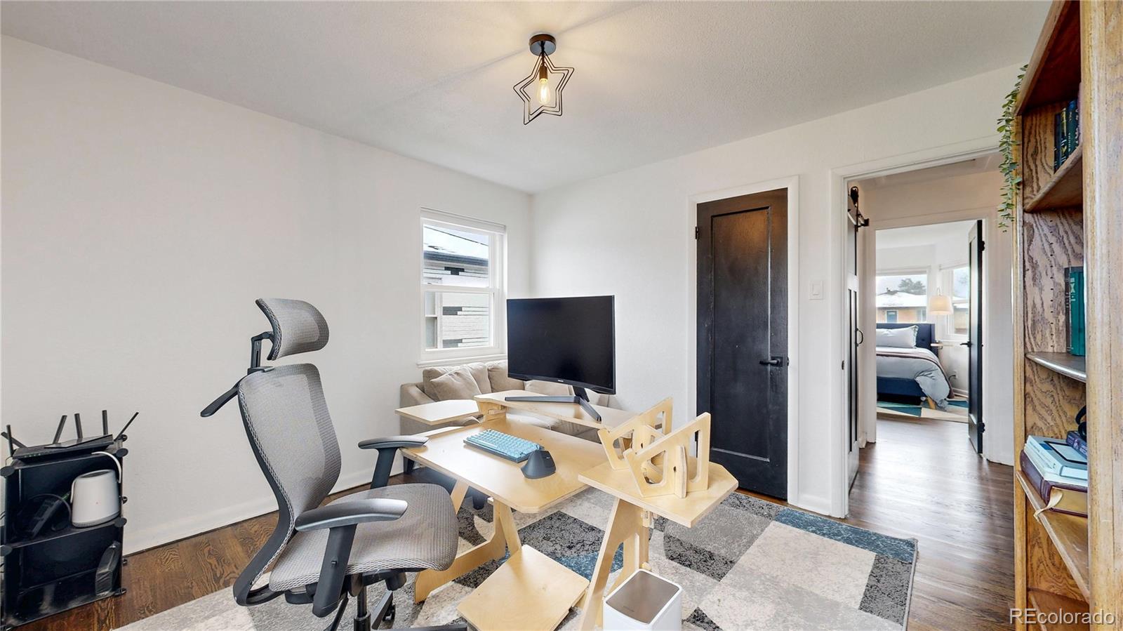 3155 Steele Street Denver, CO 80205 - Photo 17 of 37 a view of a workspace with furniture and wooden floor