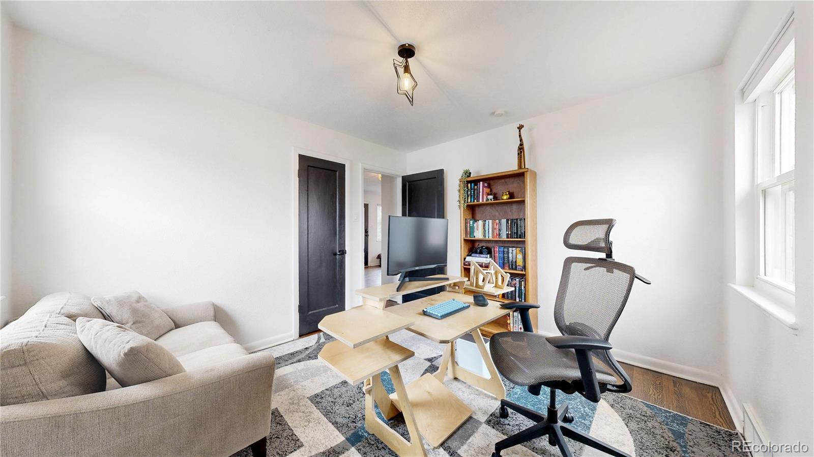 3155 Steele Street Denver, CO 80205 - Photo 18 of 37 a work room with furniture and a window