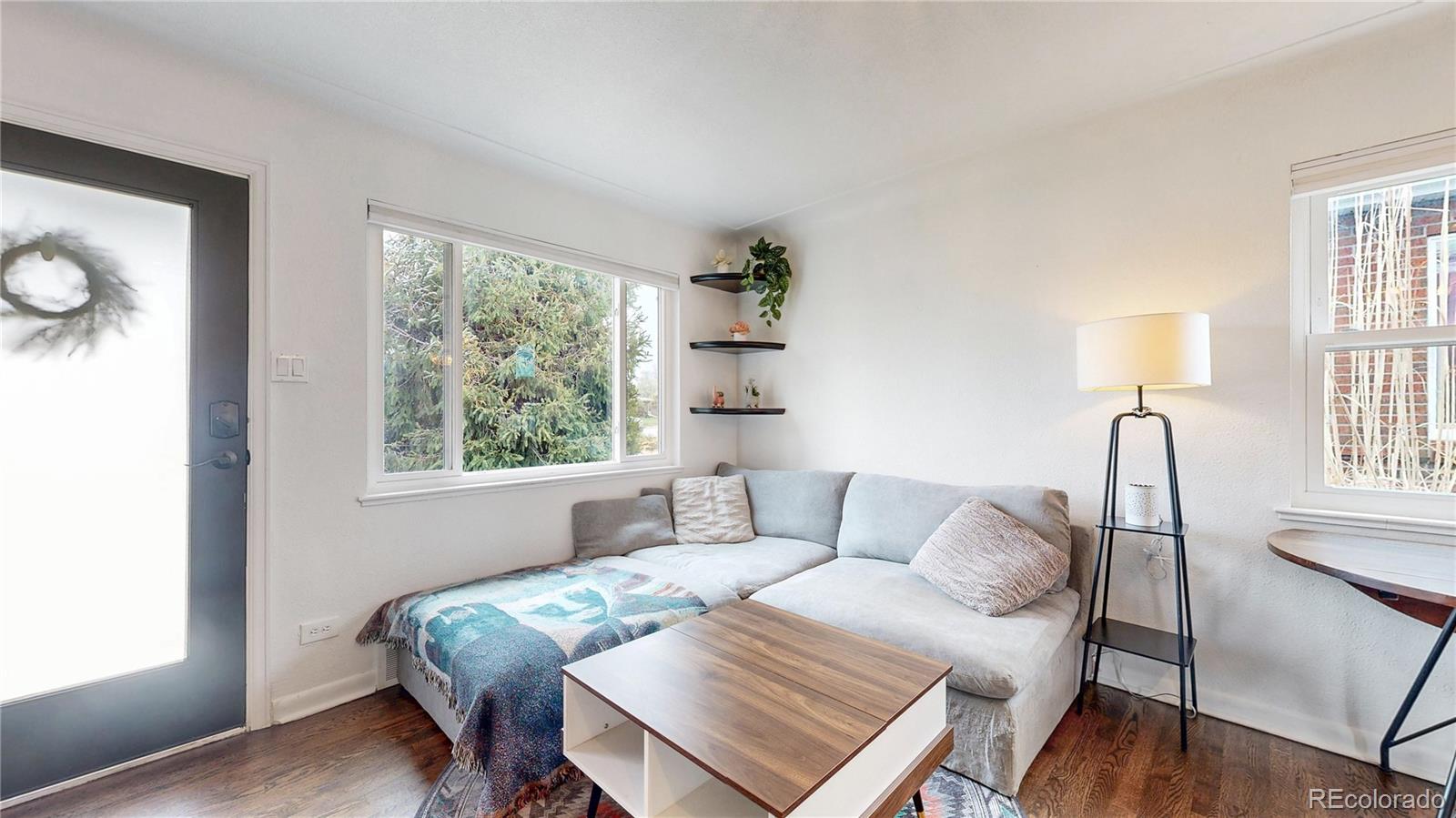 3155 Steele Street Denver, CO 80205 - Photo 2 of 37 a living room with furniture and a window