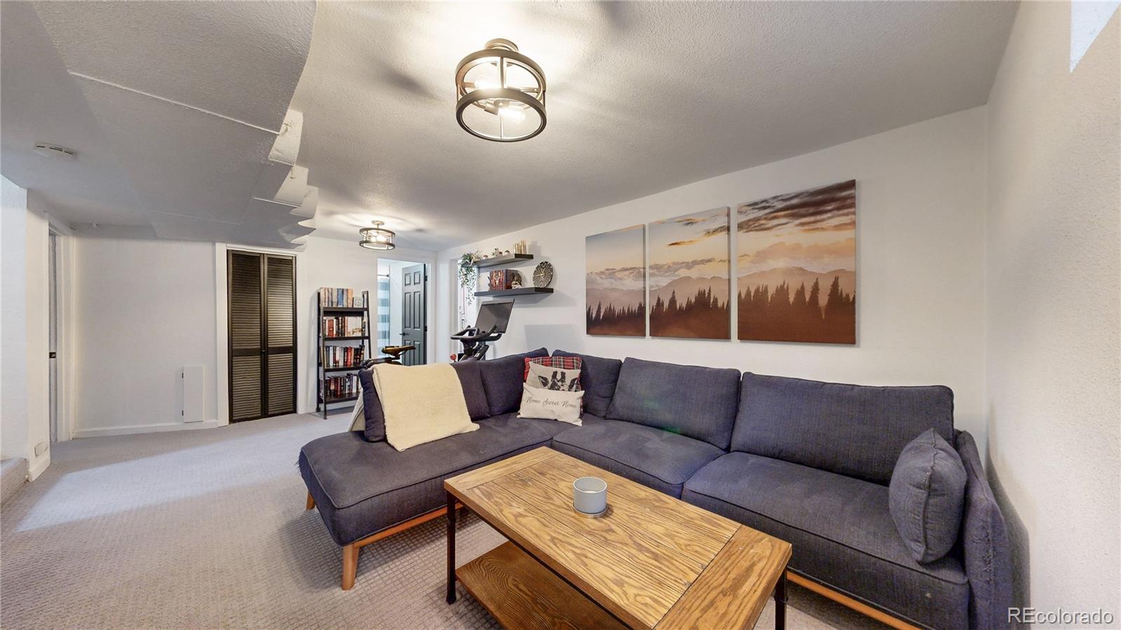 3155 Steele Street Denver, CO 80205 - Photo 27 of 37 a living room with furniture and a large window