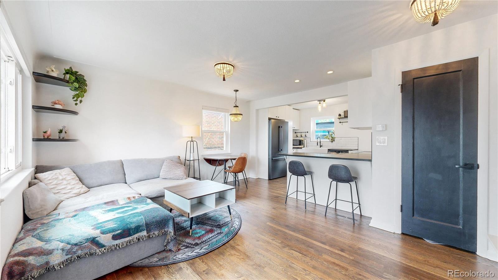 3155 Steele Street Denver, CO 80205 - Photo 3 of 37 a living room with furniture and a wooden floor