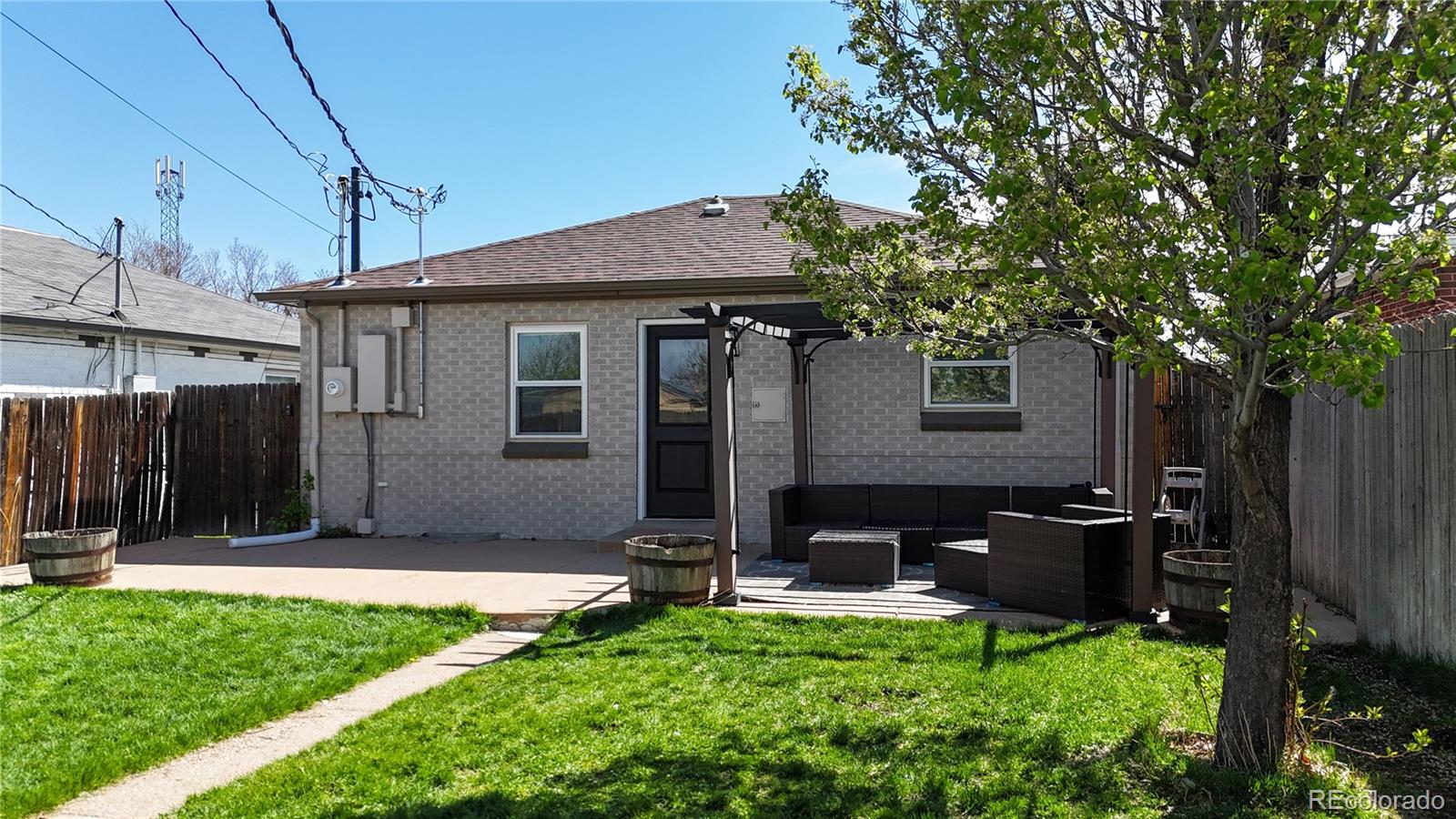 3155 Steele Street Denver, CO 80205 - Photo 37 of 37 a backyard of a house with table and chairs