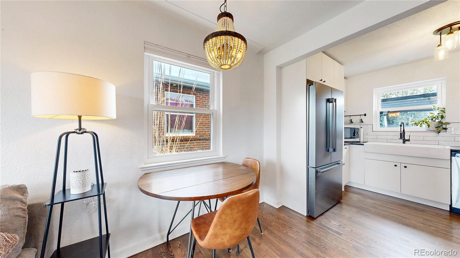 3155 Steele Street Denver, CO 80205 - Photo 5 of 37 a view of kitchen with a refrigerator a sink and a mirror