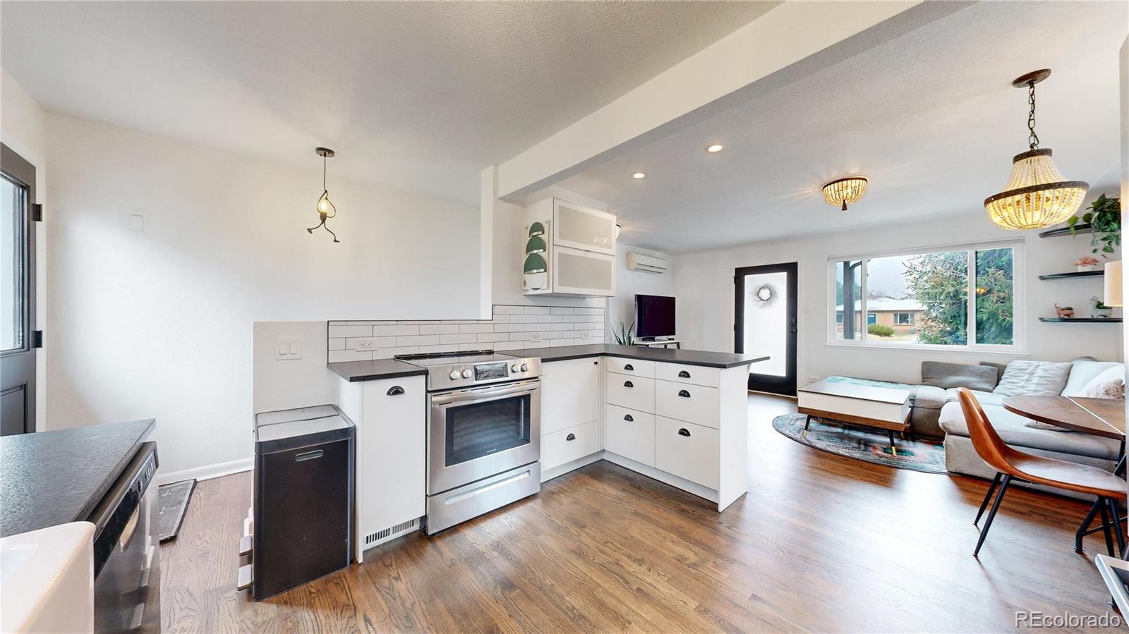 3155 Steele Street Denver, CO 80205 - Photo 8 of 37 a kitchen with a stove a sink and a refrigerator